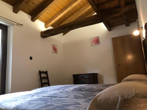 a bedroom with a bed and a wooden ceiling at Urruti in Zilbeti