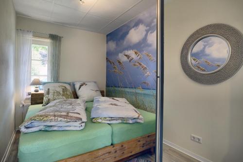 a bedroom with a bed with a painting on the wall at Seelavie in Zingst