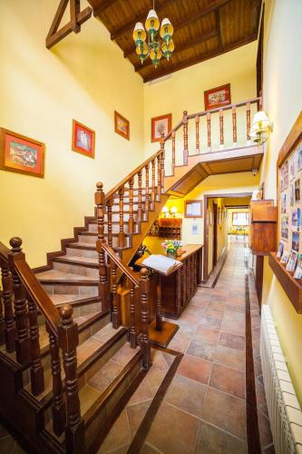 a large staircase in a house with a stair case at Hotel Campanilla in Ushuaia