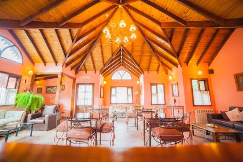 a large room with tables and chairs in a building at Hotel Campanilla in Ushuaia