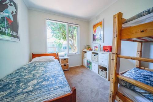 a bedroom with two bunk beds and a window at 150 Steps FREE WI-FI in Apollo Bay