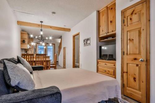 a bedroom with a bed and a living room at Banff Gate vacation townhouse in Canmore