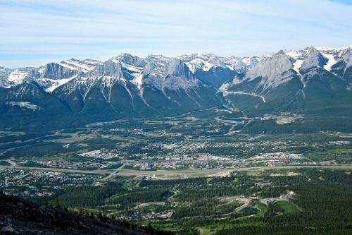 an aerial view of a valley with snow covered mountains at Banff Gate vacation townhouse in Canmore