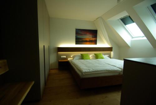 a small bedroom with a bed with a window at Pfänder in Bettnau