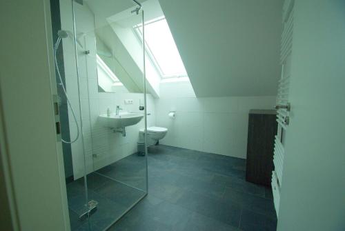 a bathroom with a glass shower and a sink at Pfänder in Bettnau