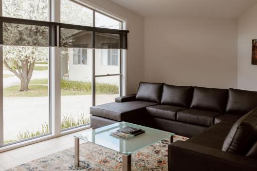 a living room with a couch and a glass table at Tindarra Resort in Moama