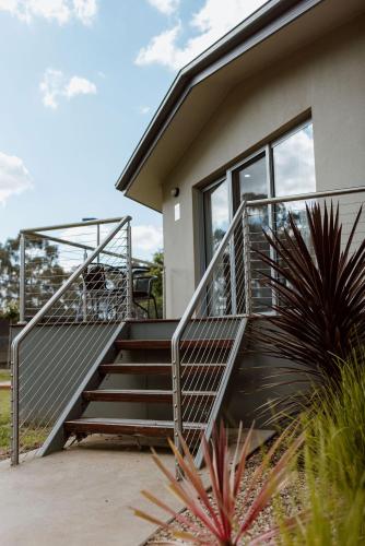 a house with a metal staircase in front of it at Tindarra Resort in Moama