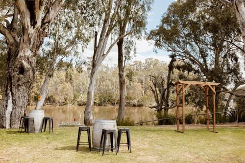 a group of tables and chairs in a park at Tindarra Resort in Moama