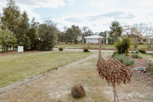 a statue of an ostrich standing in a yard at Tindarra Resort in Moama