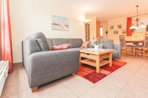 a living room with a couch and a table at Ostseeresidenz - Whg 29 in Zingst