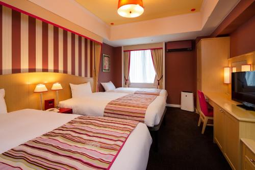 Hotel Monterey Kyoto tesisinde bir odada yatak veya yataklar