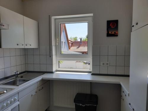 a kitchen with a sink and a window at Ferienwohnung Bernhard in Germersheim