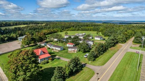 an aerial view of a house with a road and trees at Cavendish Lodge & Cottages in Cavendish