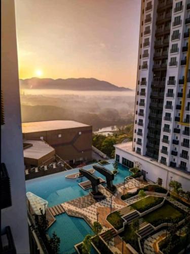 a view of a building with a swimming pool in the foreground at Mesahill Nilai 2 Room Condo - Fast wifi, Amazing Pool & TV in Nilai