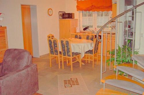 a dining room with a table and chairs at Am Deich 33 in Zingst