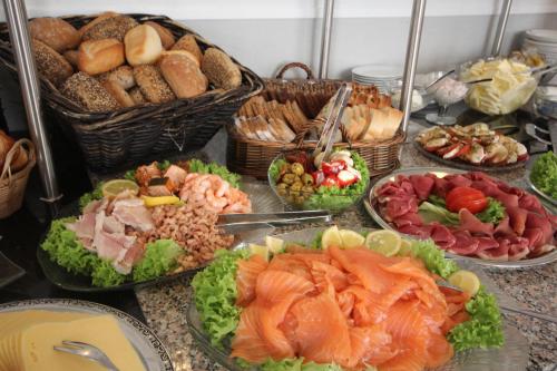 a buffet of different types of food on a table at Hotel Villa Undine in Grömitz