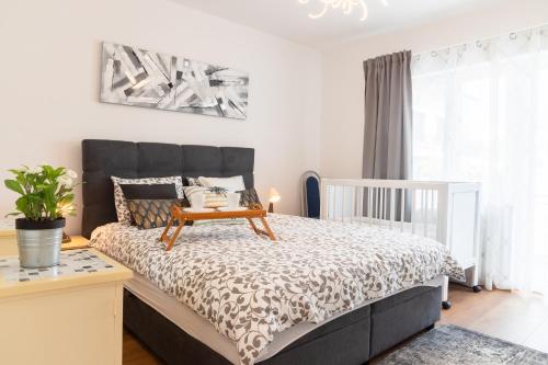 a bedroom with a bed with a black and white comforter at Apartmani Vesna Tuheljske toplice in Tuheljske Toplice