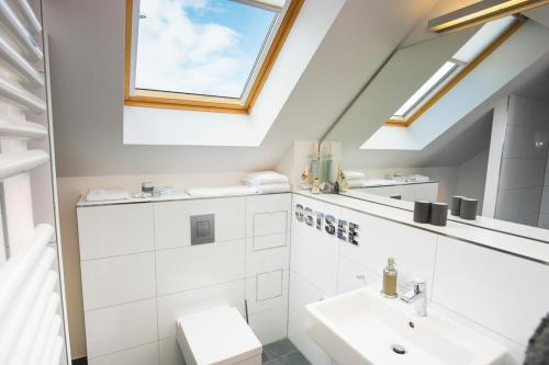a bathroom with a sink and a mirror at Ostsee - Appartement Nr 64 "MeerZeit" im Strand Resort in Heiligenhafen
