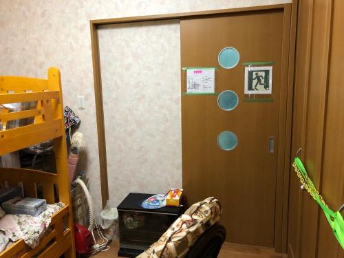 a room with a sliding door in a bedroom at Guest in Shallman in Amami