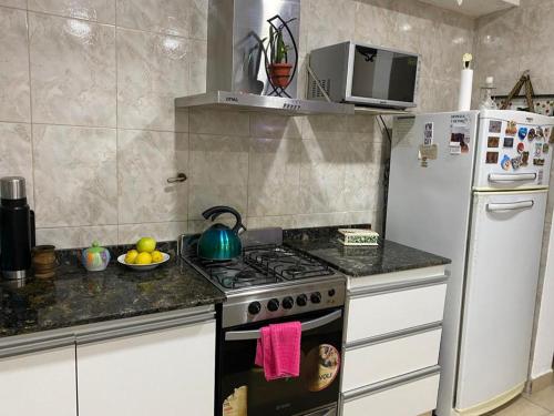a kitchen with a stove and a refrigerator at Departamento Tafí Viejo in Tafí Viejo