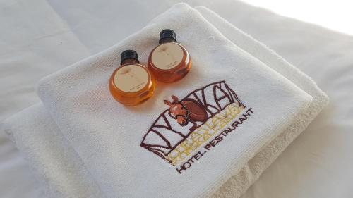 two bottles of honey sitting on top of a napkin at Hotel Farma Vysoká in Chrastava