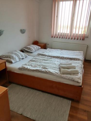 a bed with two pillows on it in a bedroom at Šulentić sobe i restoran in Virovitica