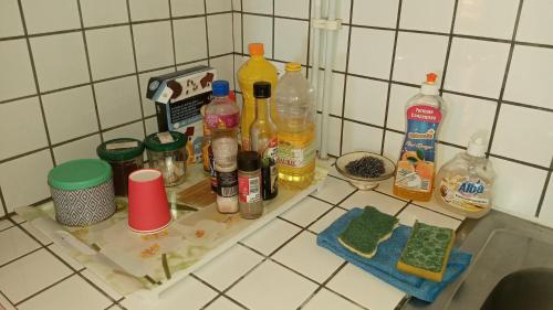 a kitchen counter with a bunch of bottles on it at Manava Tahara'a Home Stay in Mahina