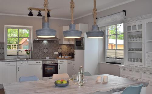 a kitchen with a table and some blue chairs at Reethaus 1B in Staberdorf