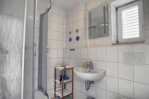 a bathroom with a sink and a shower at Altes Wasserwerk, FW 9 in Zingst
