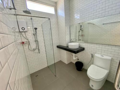 a white bathroom with a shower and a toilet at Pure Laguna Residence by Nice Sea Resort in Srithanu
