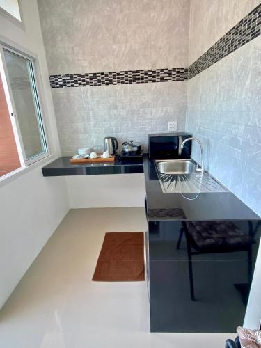 a small kitchen with a sink and a counter at Pure Laguna Residence by Nice Sea Resort in Srithanu
