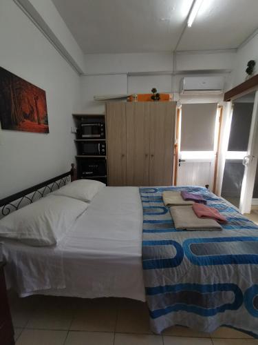 a bedroom with a bed with a blanket on it at Nicosia rooms Studios in Nicosia
