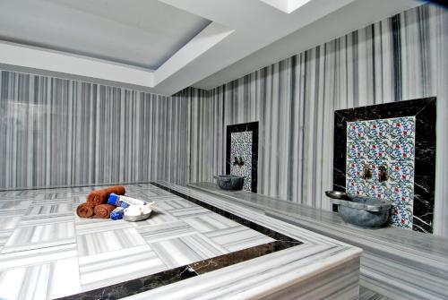 a room with a table with a tray of food on it at Kleopatra Ramira Hotel - All Inclusive in Alanya