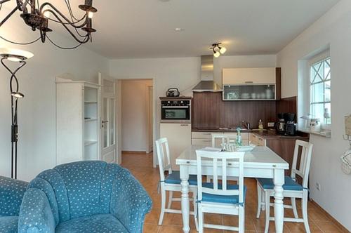a kitchen and dining room with a table and chairs at Villa Carpe Diem, FW 8 in Zingst