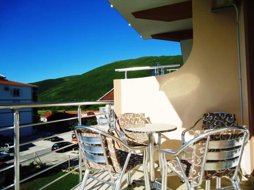a table and chairs on a balcony with a view at Apartments Nedovic-Jaz in Budva