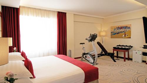 a hotel room with a bed and a desk at Kempinski Hotel Khan Palace in Ulaanbaatar