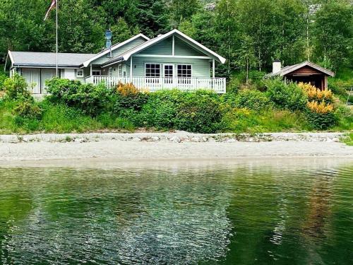 a house on the shore of a body of water at 8 person holiday home in j rpeland in Jørpeland