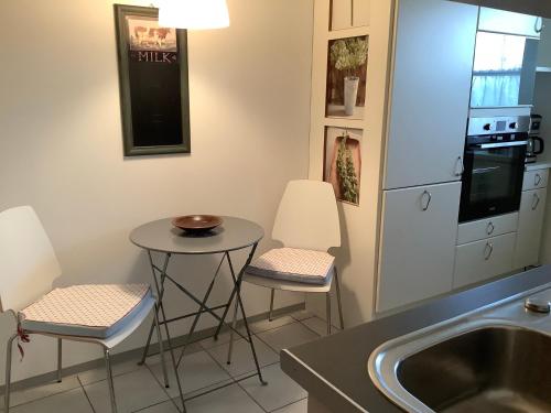 a kitchen with two stools and a table and a sink at Hanni und Nanni in Haldenwang