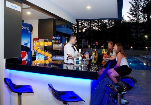 a group of people sitting at a bar at Kleopatra Ramira Hotel - All Inclusive in Alanya