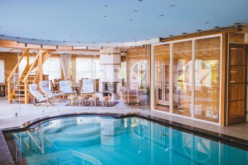 a swimming pool in a house with glass walls at Haus Irsa in Sellingen