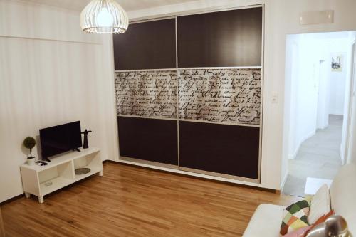 a living room with a tv and a wall at Athens central apartment with Acropolis views! - SQ1 in Athens
