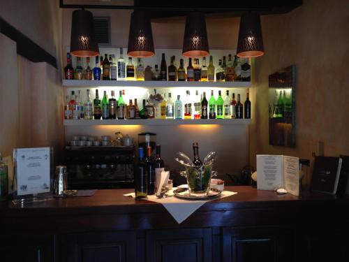 a bar with a counter with bottles of alcohol at Colonna Country Club in Porto Cervo