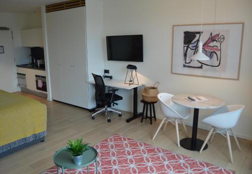 a living room with a bed and a table at PREMIER SUITES Antwerp in Antwerp