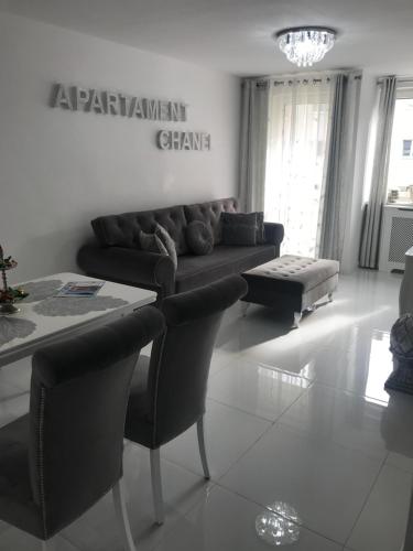 a living room with a couch and a table at Apartament Chanel Centrum in Malbork