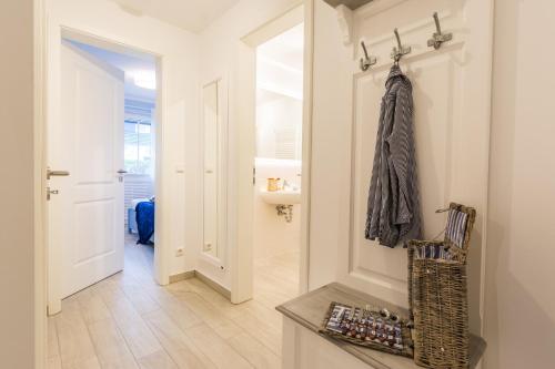 a room with a hallway with a door and a coat hanging at Whg 02 - MeerFreude in Zingst