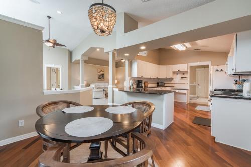 a kitchen and dining room with a table and chairs at Peaceful Waterfront Pool Home home in Palm Coast
