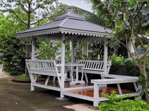 a white gazebo with a table and benches at Superior House Khaoyai in Ban Khanong Phra Klang (1)