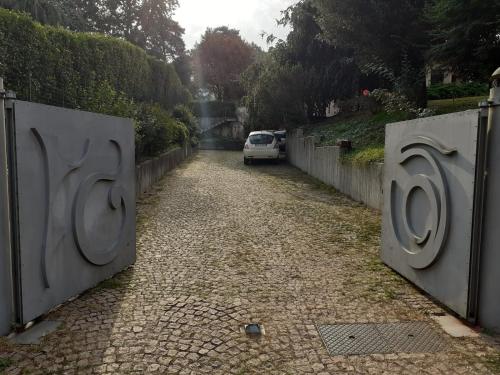 a car driving down a road between two gates at Bed & Breakfast Viadelgolf41 in Carimate