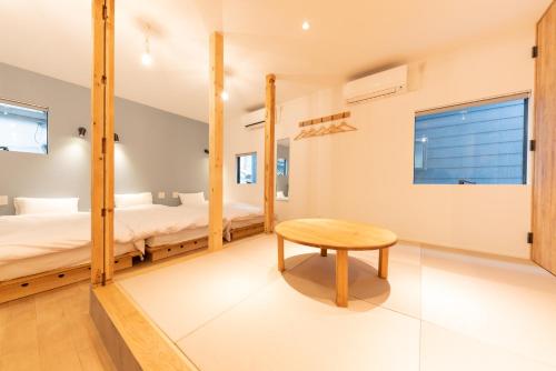 a bedroom with two bunk beds and a table at 強羅base A棟 - GORA Base A in Gora