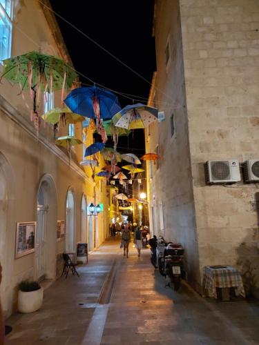 an alley with umbrellas hanging from the ceilings at Center apartment Golden Ray in Bol